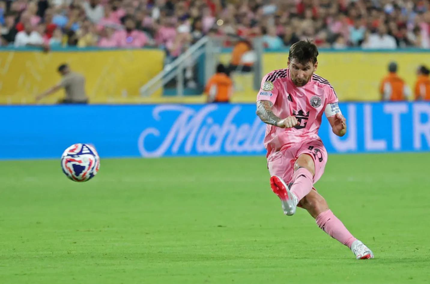 A stadium full of fans watching a soccer game, with the Inter Miami logo visible.