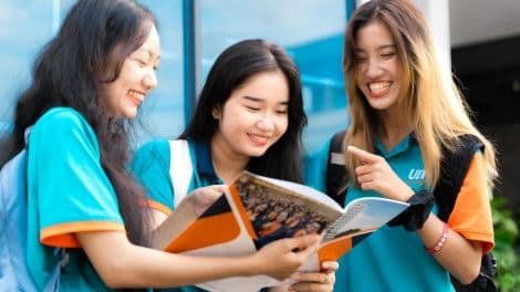 Ba người trẻ đang xem tài liệu, tượng trưng cho việc tìm hiểu và thích nghi với các quy định thuế mới cho hộ kinh doanh theo Quyết định 1272