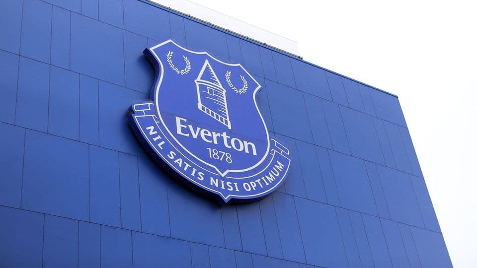 Biểu tượng câu lạc bộ Everton trên tòa nhà xanh, tượng trưng cho án phạt tài chính và vụ kiện bồi thường.