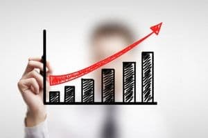 Biểu đồ tăng trưởng với mũi tên đi lên, thể hiện mục tiêu phát triển bền vững và giá trị kiến tạo của doanh nghiệp.