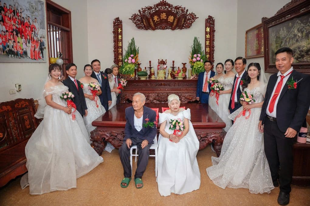 Cụ Nguyễn Thị Cử và cụ Vũ Văn Tiện 93 tuổi cùng sáu người con trong trang phục cưới tại hôn lễ tái hiện ở nhà.