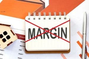 Chữ 'MARGIN' bị gạch chéo trên sổ ghi chú, biểu thị sự cắt giảm hoặc thất bại tài chính, một bài học đắt giá cho startup.