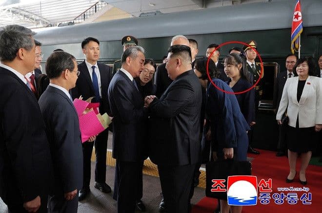 Chủ tịch Triều Tiên Kim Jong Un bắt tay quan chức Trung Quốc tại lễ duyệt binh, thể hiện mối quan hệ ngoại giao.
