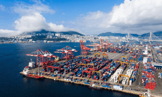 Cảng biển với nhiều container, minh họa cho hoạt động thương mại quốc tế và chính sách thuế quan.