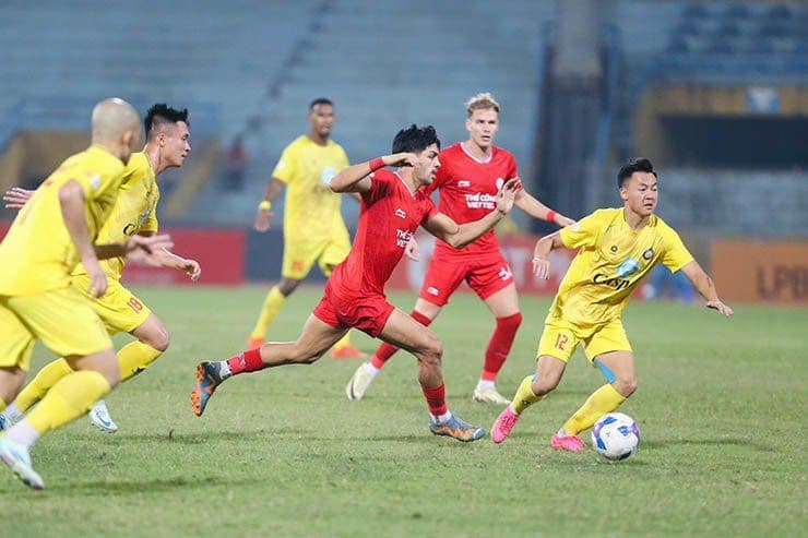 Cầu thủ Thể Công Viettel (áo đỏ) tranh bóng quyết liệt với cầu thủ Thanh Hóa (áo vàng) trong trận đấu V-League.