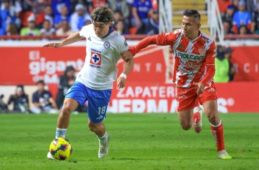 Hai cầu thủ bóng đá của Necaxa và Cruz Azul tranh chấp bóng quyết liệt trên sân cỏ