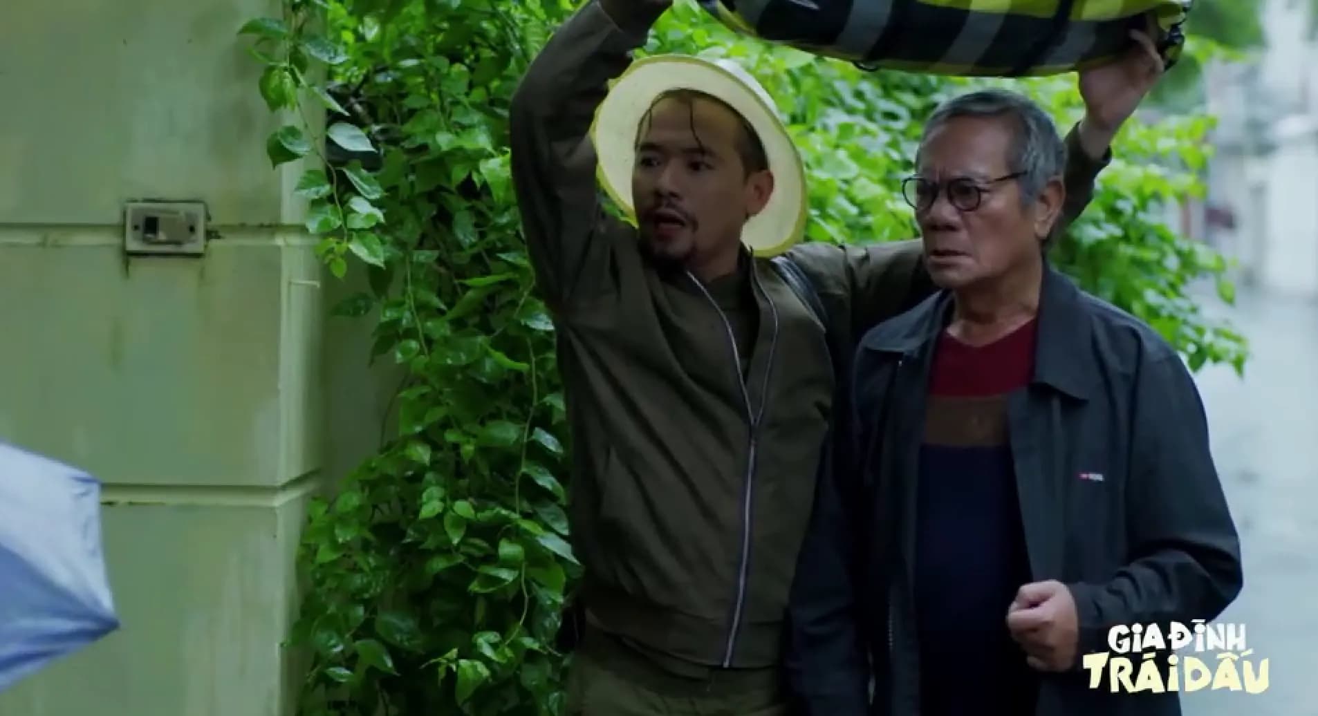 Hai người đàn ông trong phim 'Gia Đình Trái Dấu' với vẻ mặt lo lắng, thể hiện sự căng thẳng và kịch tính của tập phim.