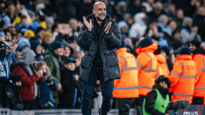 HLV Pep Guardiola của Man City vỗ tay trên sân vận động, thể hiện sự hài lòng