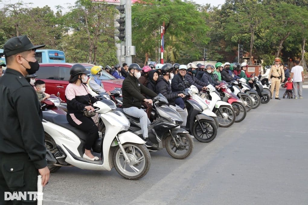 Hàng dài xe máy chờ đèn đỏ, thể hiện tình trạng giao thông phức tạp và ùn tắc tại Việt Nam.