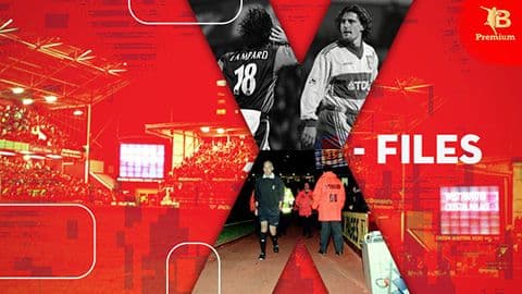 Hình ảnh cầu thủ, trọng tài và khán giả trên sân, thể hiện không khí căng thẳng của một trận đấu bóng đá quyết định.