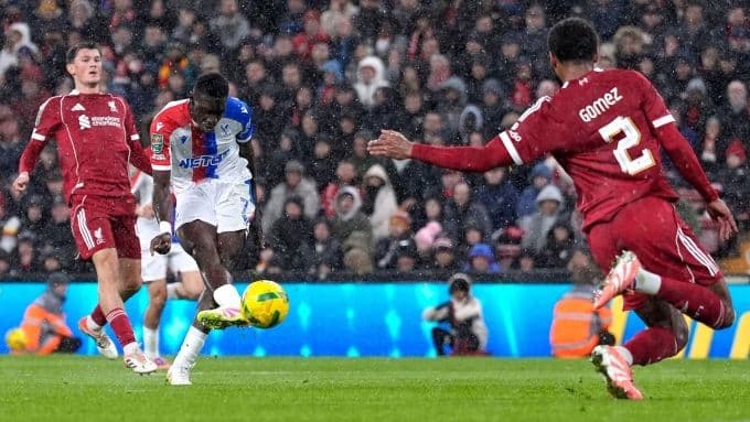 Ismaila Sarr (áo trắng) ghi bàn vào lưới Liverpool (áo đỏ) tại Anfield, thể hiện 'lời nguyền' cho triều đại mới của Slot.