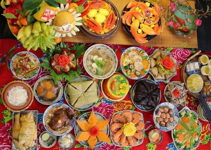 Mâm cỗ mặn truyền thống cúng ông Công ông Táo với các món ăn như gà luộc, xôi gấc, bánh chưng, chả giò, thể hiện sự đủ đầy.