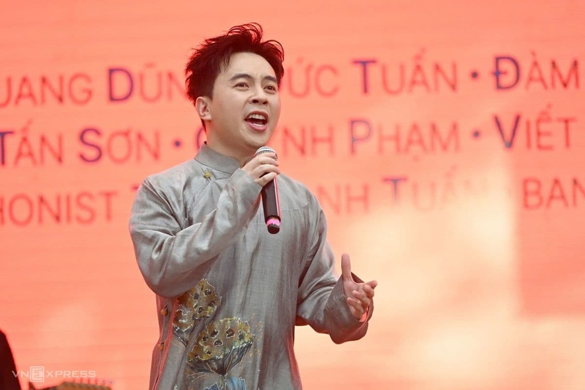 Một ca sĩ biểu diễn nhạc Trịnh trong trang phục áo dài truyền thống, tượng trưng cho xu hướng giữ gìn phong cách nguyên bản.