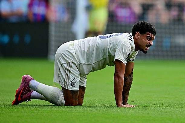 Một cầu thủ trên sân thể hiện sự căng thẳng và khó khăn trong trận đấu giữa Crystal Palace và Nottingham Forest.