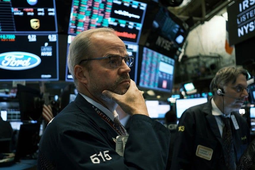 Một nhà giao dịch tại Phố Wall theo dõi dữ liệu thị trường sau quyết định cắt giảm lãi suất của Fed.