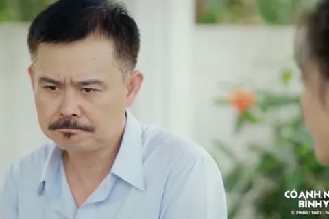 Một nhân vật nam trong phim 'Có anh, nơi ấy bình yên' với vẻ mặt suy tư, có thể liên quan đến cuộc điều tra trại lợn gây ô nhiễm.