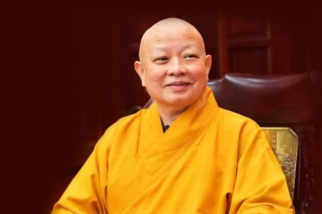 Một vị hòa thượng trong trang phục tu sĩ, tượng trưng cho Giáo hội Phật giáo Việt Nam.