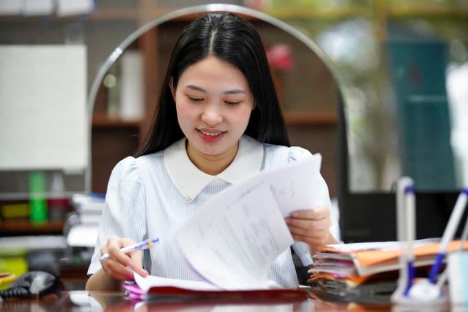 Nữ công chức đang làm việc với giấy tờ tại văn phòng, minh họa cho việc điều chỉnh lương cơ sở mới và tác động đến đời sống công chức.
