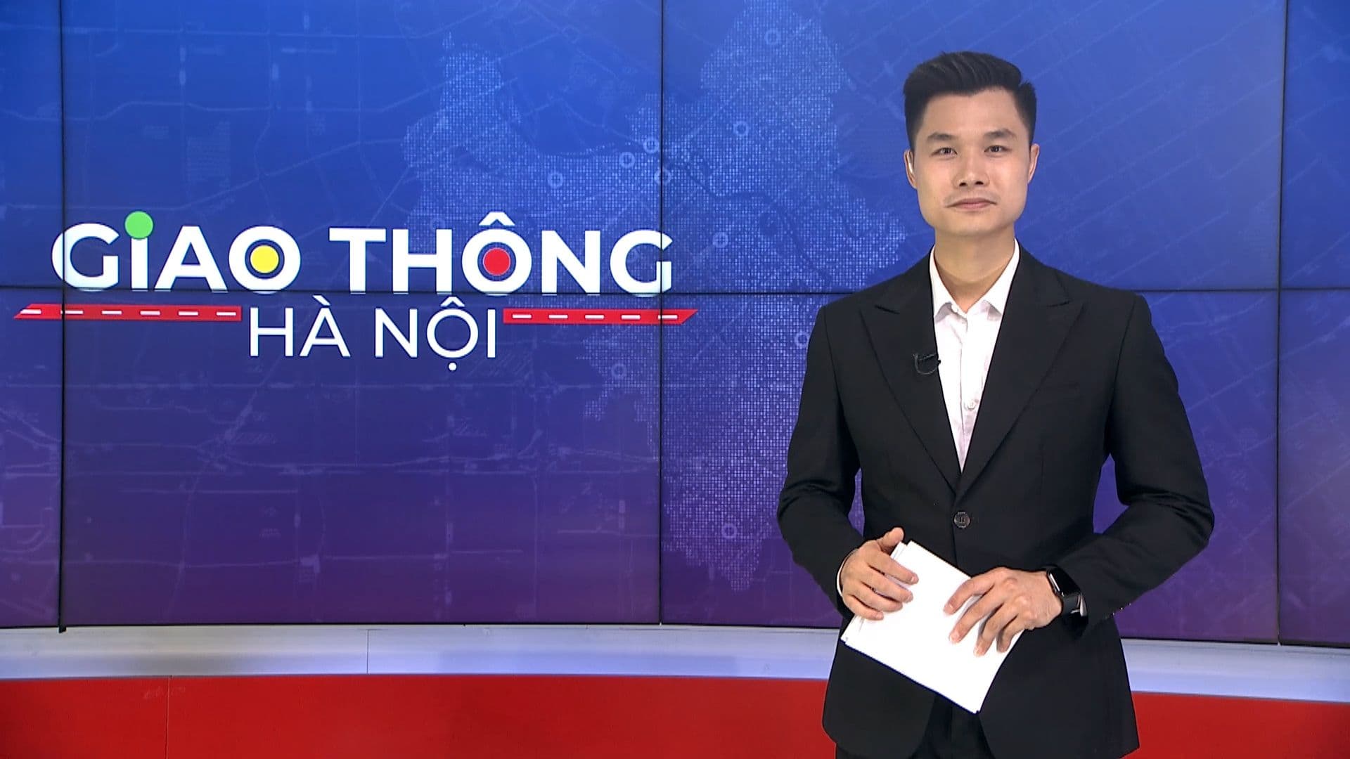 Nam phát thanh viên đưa tin về tình hình giao thông và quy định mới.