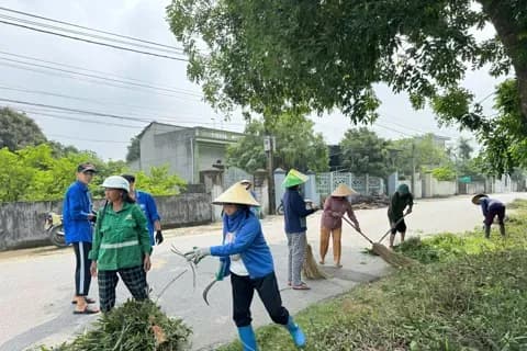 Người dân cùng nhau dọn dẹp đường làng, thể hiện sự đóng góp của xổ số vào phát triển cộng đồng và phúc lợi xã hội.