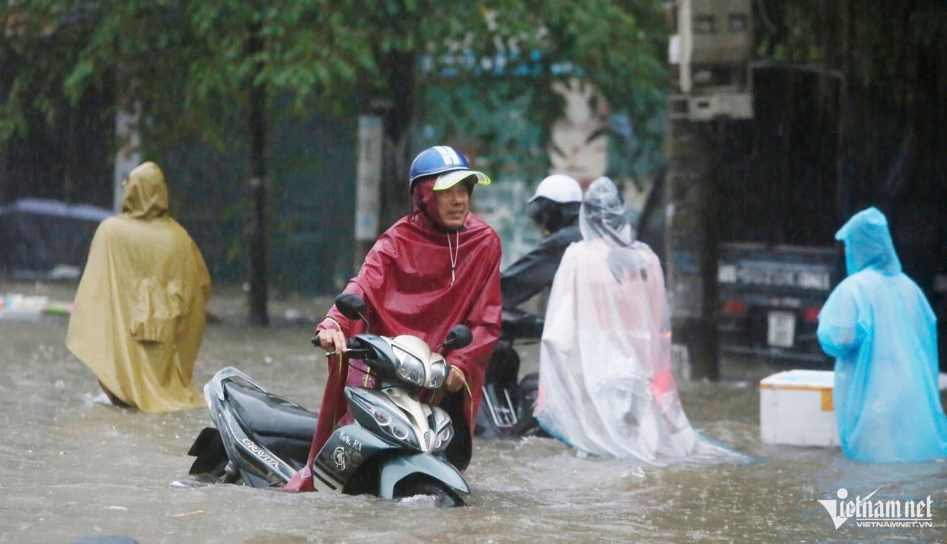 Người dân di chuyển qua đường phố Hà Nội bị ngập lụt do mưa lớn từ hoàn lưu bão Matmo, minh họa nguy cơ lũ quét.