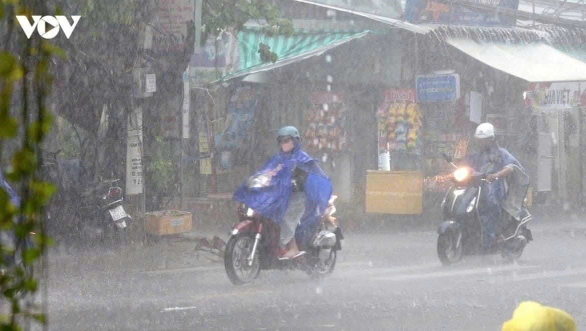 Người dân đi xe máy trong mưa lớn, minh họa tác động của dự báo thời tiết đến đời sống hàng ngày.