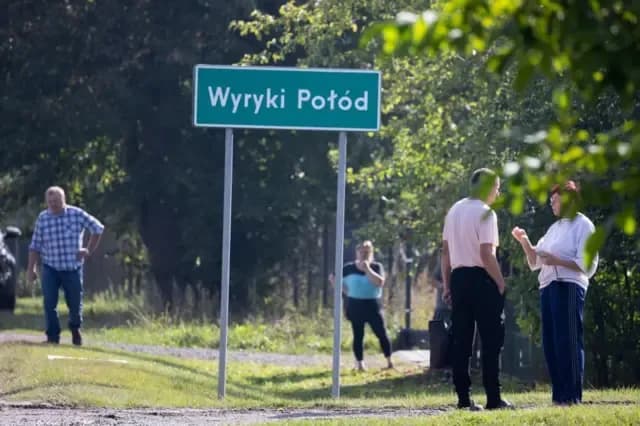 Người dân đứng trên đường sau khi một vật thể nghi là máy bay không người lái tấn công một tòa nhà dân cư ở Wyryki, Ba Lan.