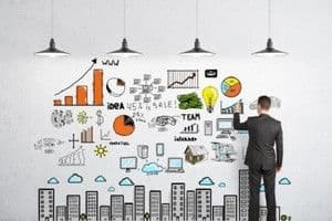 Người đàn ông vẽ sơ đồ quy hoạch đô thị và tài chính, thể hiện chiến lược tái cấu trúc và định hình tương lai.