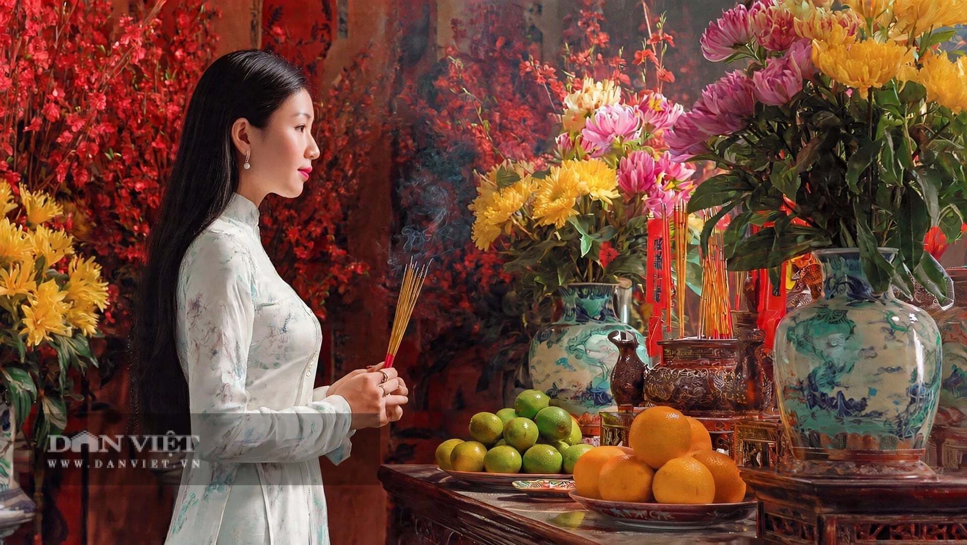 Người phụ nữ mặc áo dài trắng thành kính dâng hương, gửi gắm những lời nguyện cổ xưa trong dòng chảy cuộc sống hiện đại.