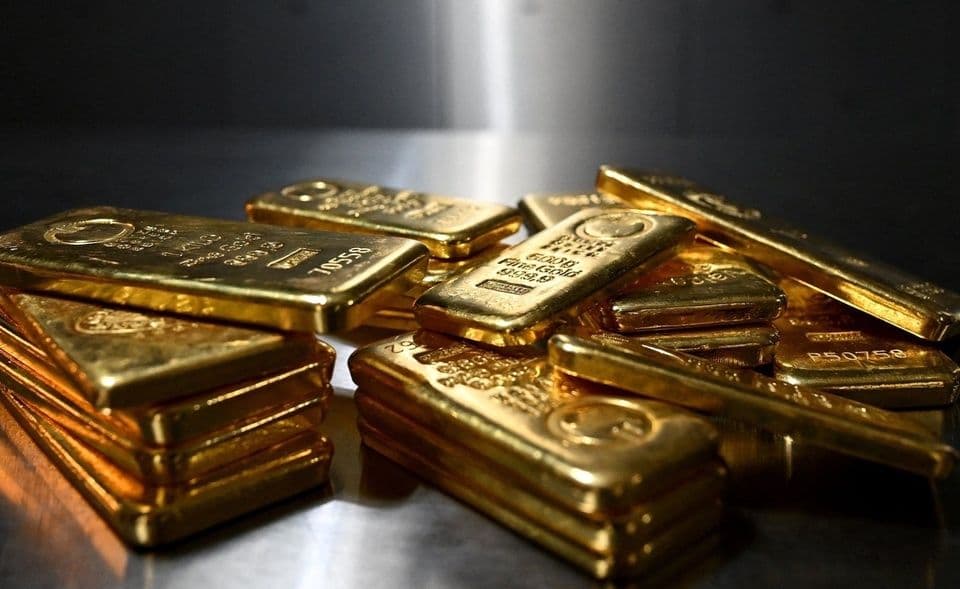 Những thỏi vàng xếp chồng lên nhau, tượng trưng cho giá trị kim loại quý đang đối mặt với sự đảo chiều trên thị trường toàn cầu.