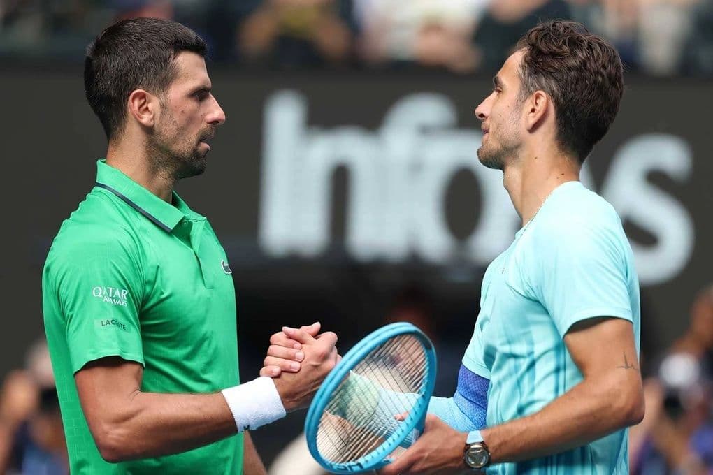 Novak Djokovic bắt tay Lorenzo Musetti sau trận đấu đầy kịch tính tại Australian Open, thể hiện tinh thần thể thao và sự vượt qua khó khăn.