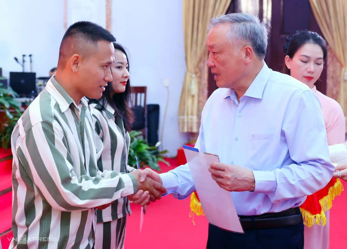 Phó Thủ tướng Thường trực Nguyễn Hòa Bình bắt tay một phạm nhân được đặc xá tại lễ công bố quyết định.