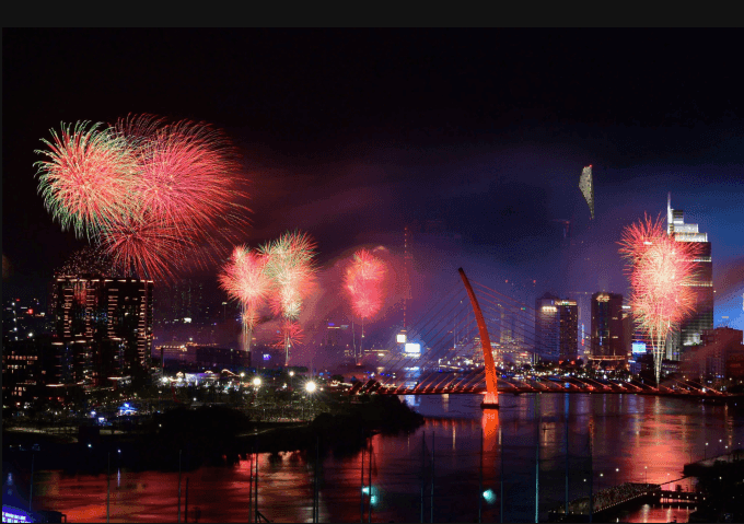 Pháo hoa rực rỡ trên sông Sài Gòn và cầu Ba Son, thắp sáng bầu trời đêm TP Hồ Chí Minh.
