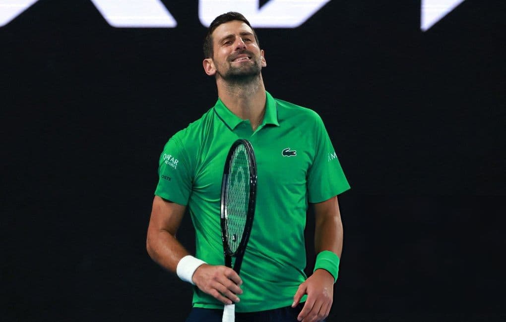 Tay vợt Novak Djokovic mỉm cười trên sân đấu, thể hiện cảm xúc chân thật và bản lĩnh của vận động viên trong những trận đấu tennis căng thẳng.