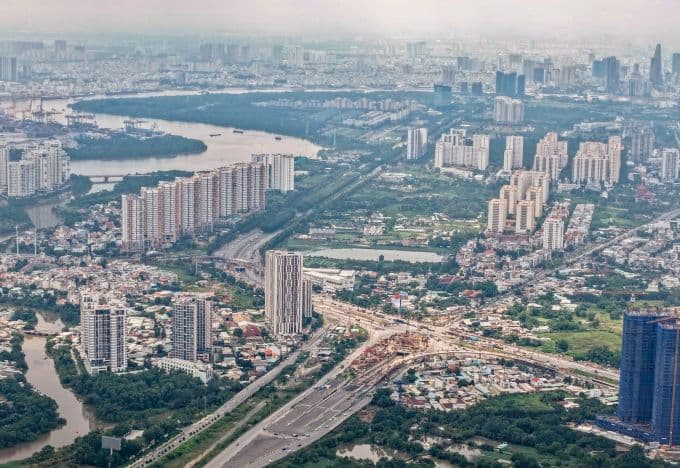 Toàn cảnh khu đô thị với nhiều tòa nhà cao tầng và sông, thể hiện sự phát triển kinh tế và các dự án bất động sản đang được Thanh tra Chính phủ giám sát.