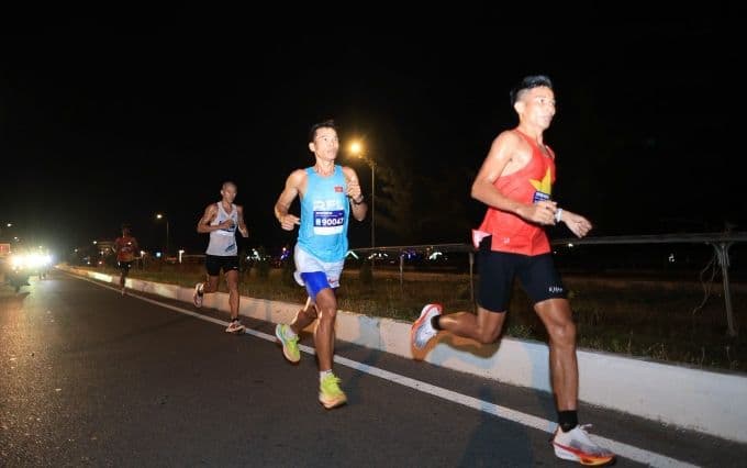 Vận động viên chạy marathon tại Nha Trang vào buổi tối, mang theo tinh thần dân tộc và khát vọng non sông.