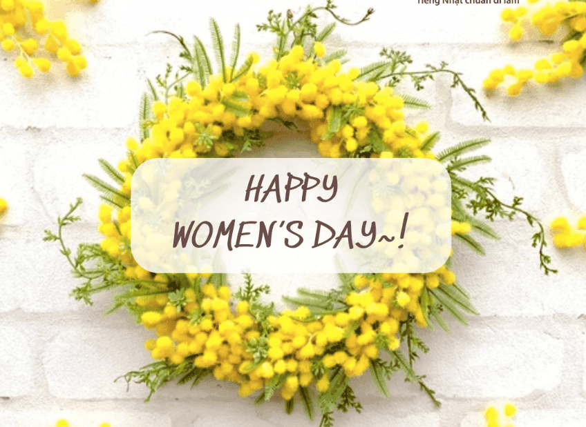 Vòng hoa mimosa màu vàng với dòng chữ 'Happy Women's Day' tượng trưng cho Ngày Quốc tế Phụ nữ.